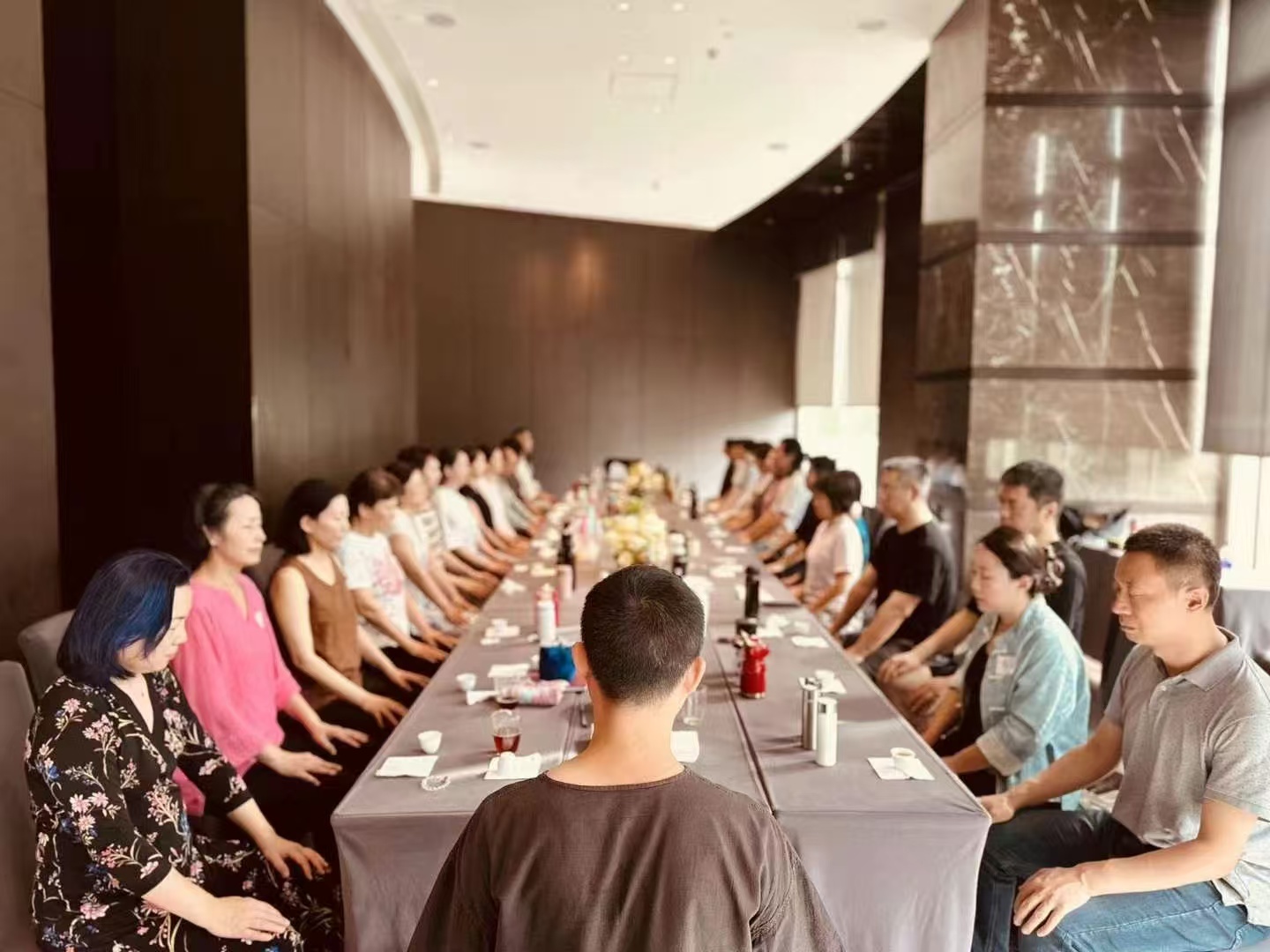 Participants practicing seated wellness exercises together in a workshop